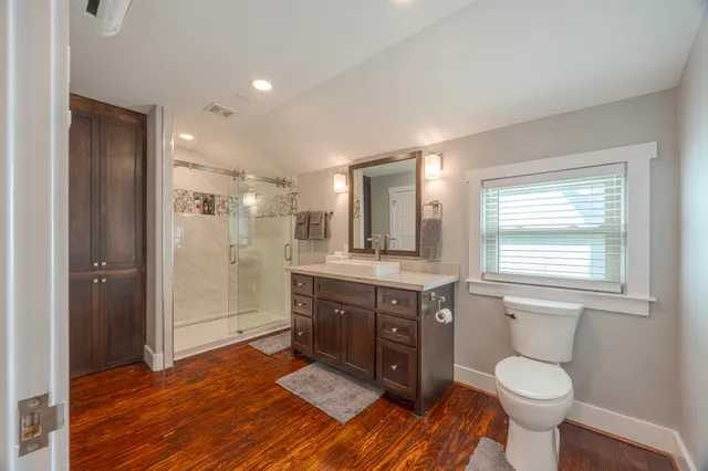 a spacious bathroom with a granite countertop sink and a mirror