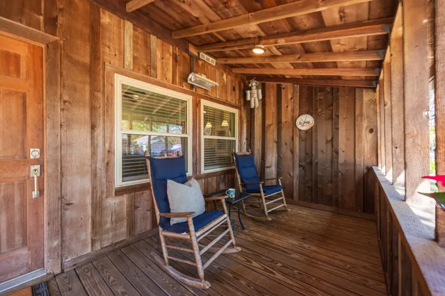 a view of a chairs and table in the balcony