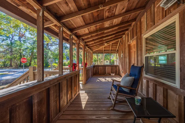 a living room with furniture and a view of kitchen