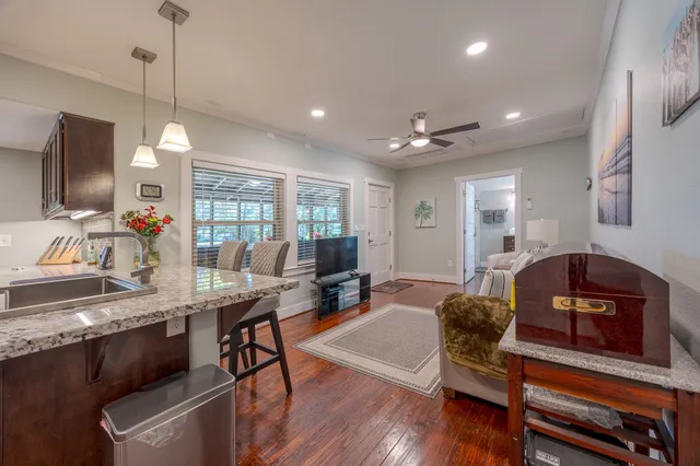 a dining room with furniture and wooden floor