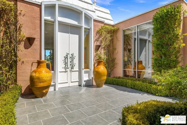 a living room with furniture fireplace and a large window