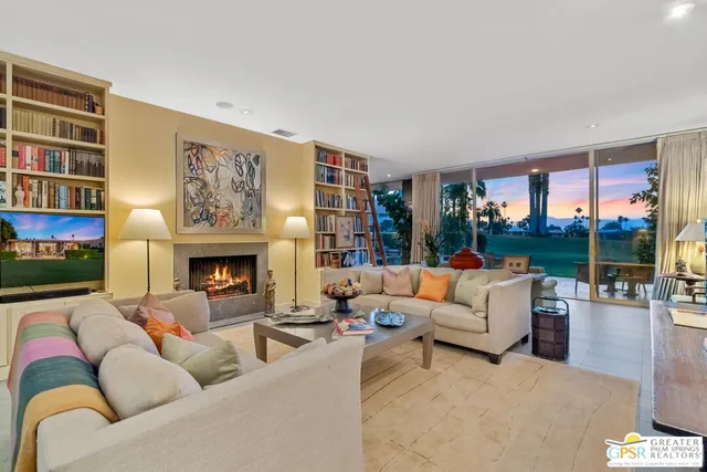 a living room with patio area and garden view