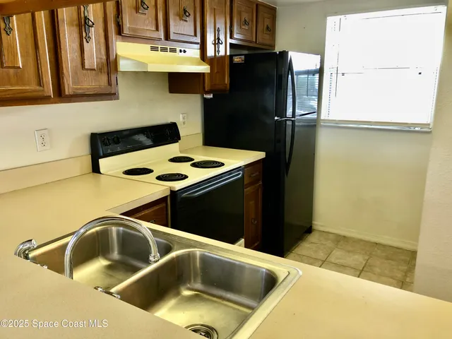 a kitchen that has a sink and a stove