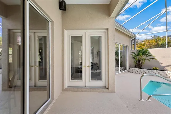 a kitchen with stainless steel appliances a sink a stove a refrigerator and white cabinets