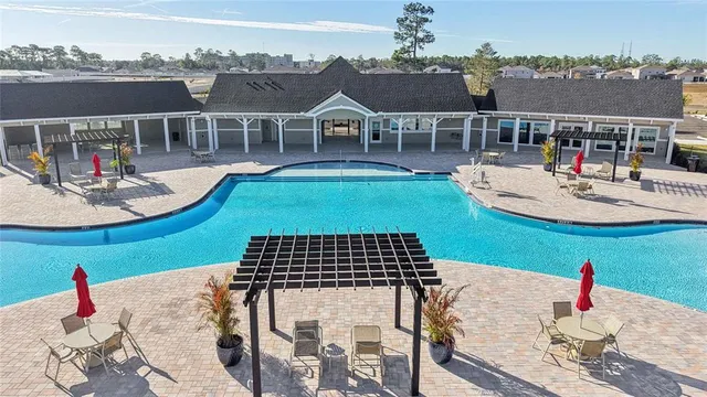an aerial view of a house with swimming pool and lake view