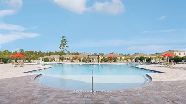 a view of a swimming pool and an outdoor seating