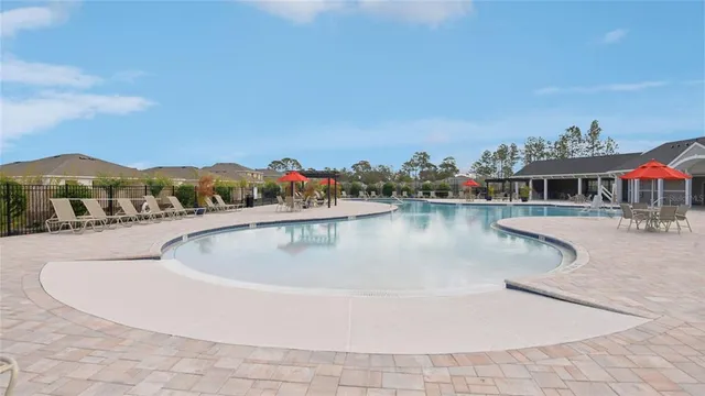a view of a swimming pool with a table and chairs