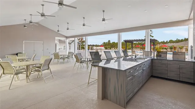a large white kitchen with a large window