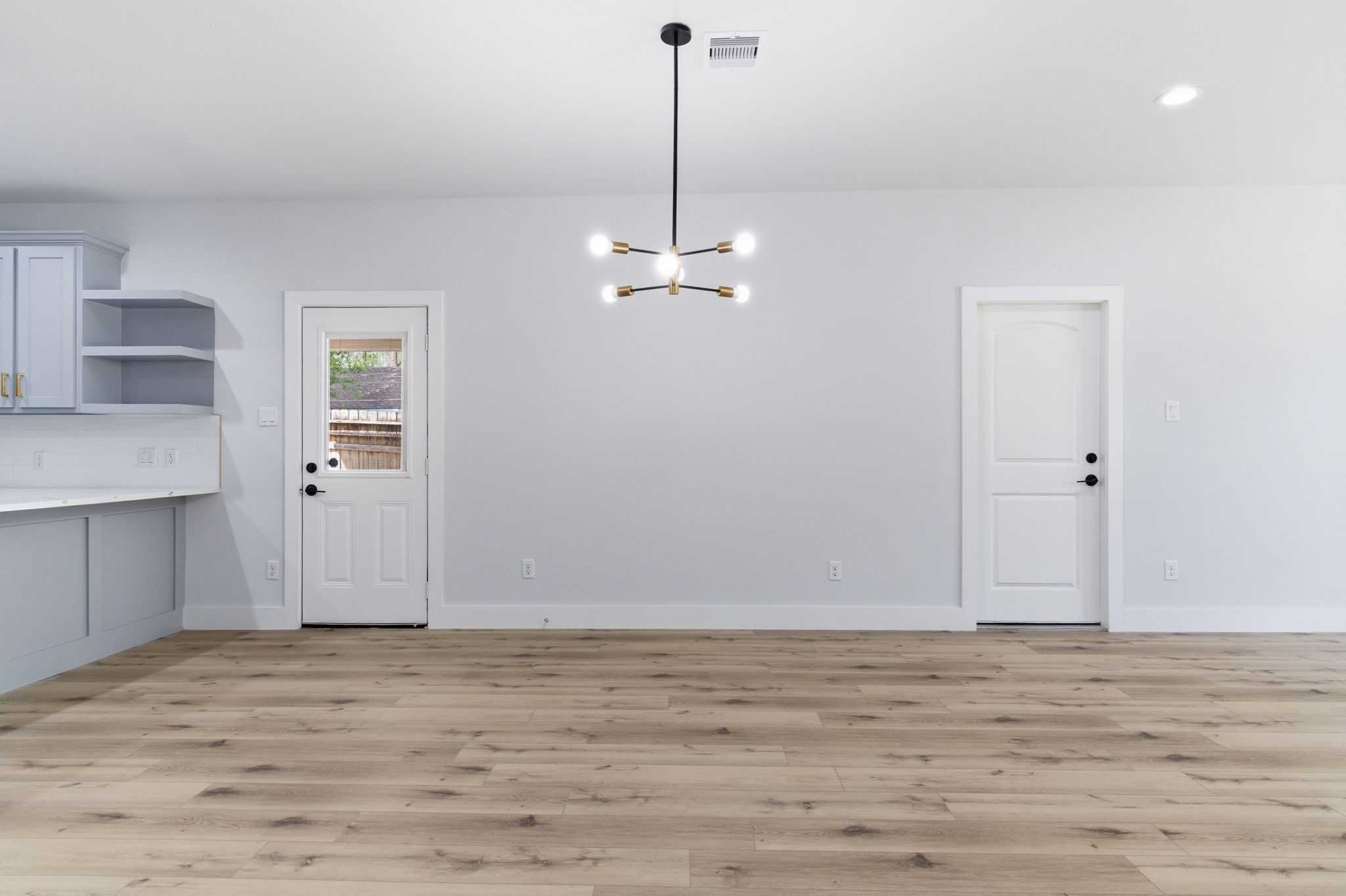 7040 Kinney Street Houston, TX 77087 - Photo 10 of 47 a view of a room with wooden floor and a ceiling fan