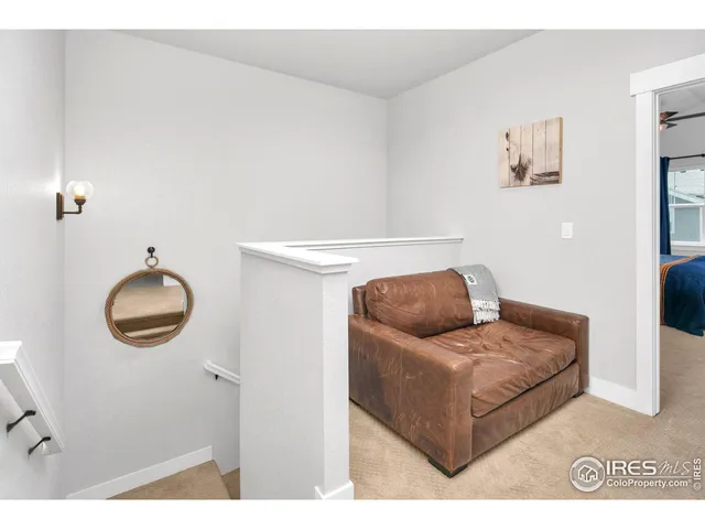 a living room with furniture and a mirror
