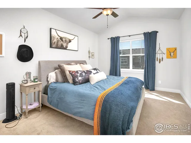 a bedroom with a bed dresser and window