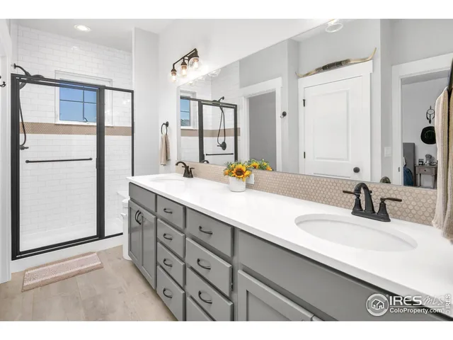 a bathroom with a sink double vanity and a mirror