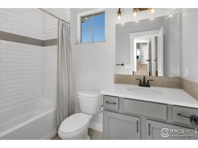 a bathroom with a sink toilet vanity and tub