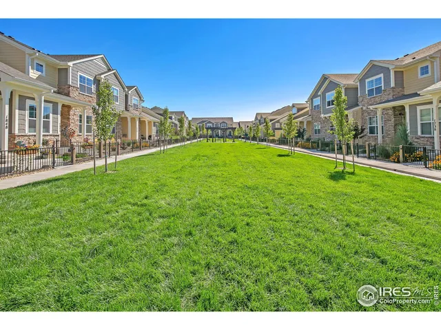 a view of a garden with a building in the background