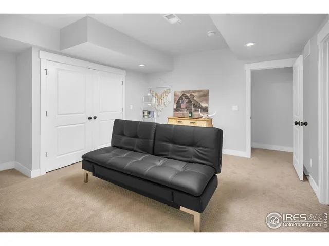 a living room with furniture and a walk in closet