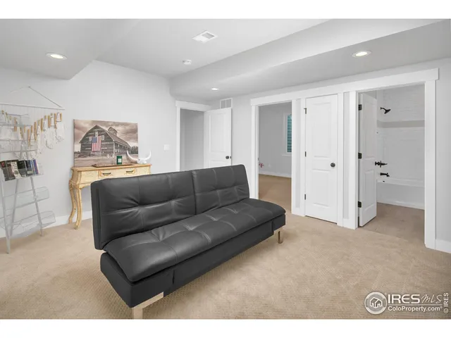 a living room with furniture and a ceiling fan