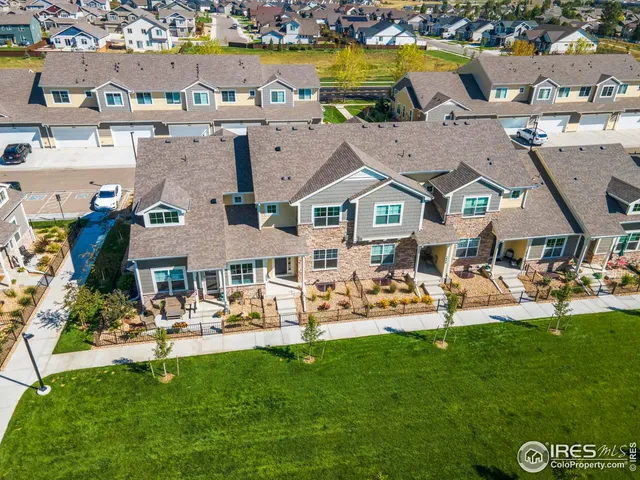 a front view of multiple houses with yard