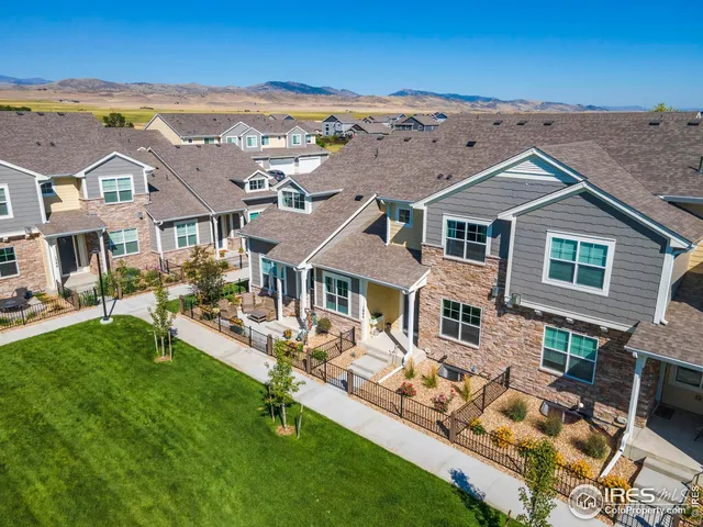 an aerial view of a house with swimming pool patio and outdoor seating