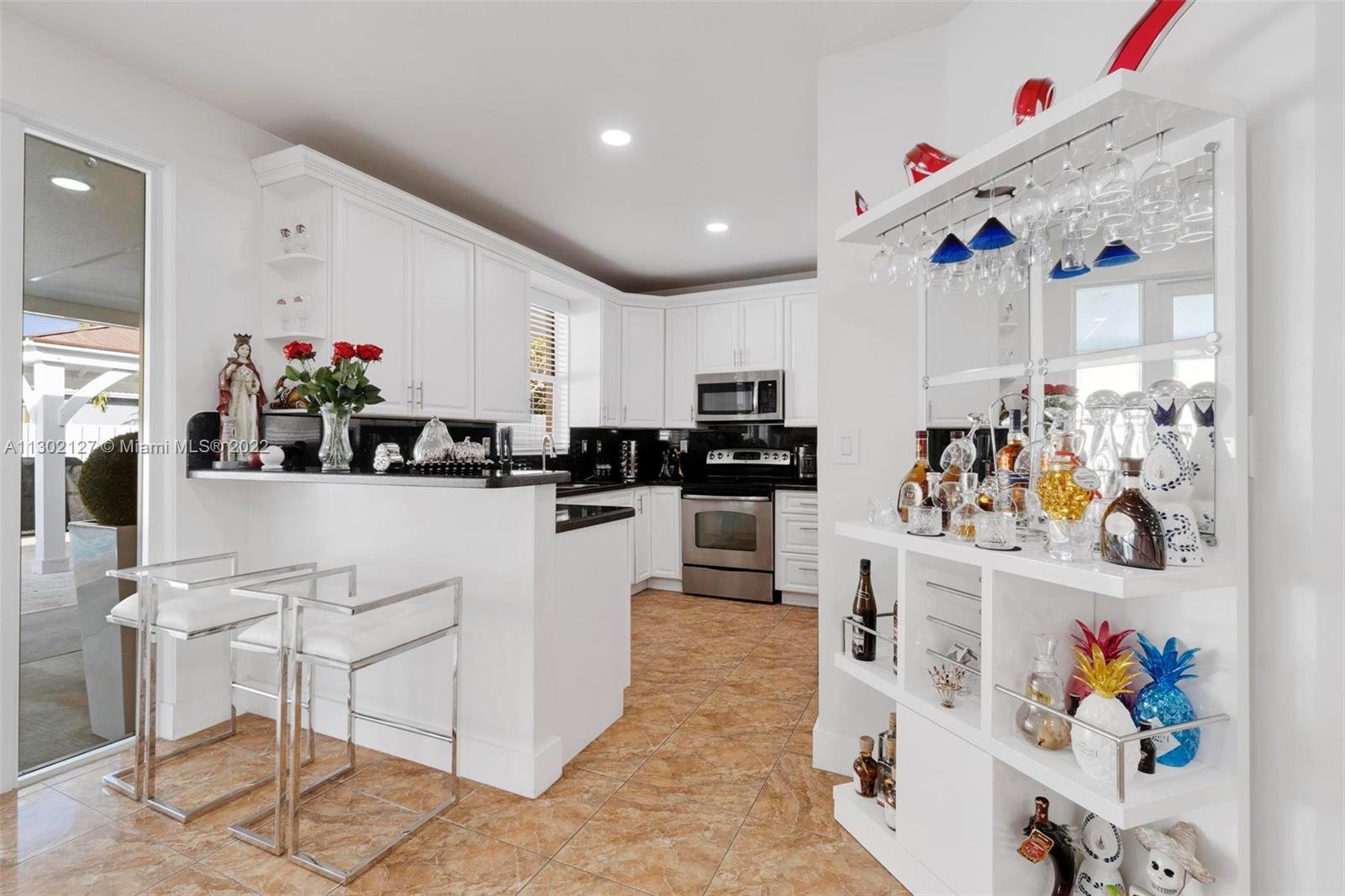 10837 Southwest 246th Street Homestead, FL 33032 - Photo 11 of 44 a kitchen with white cabinets and white appliances