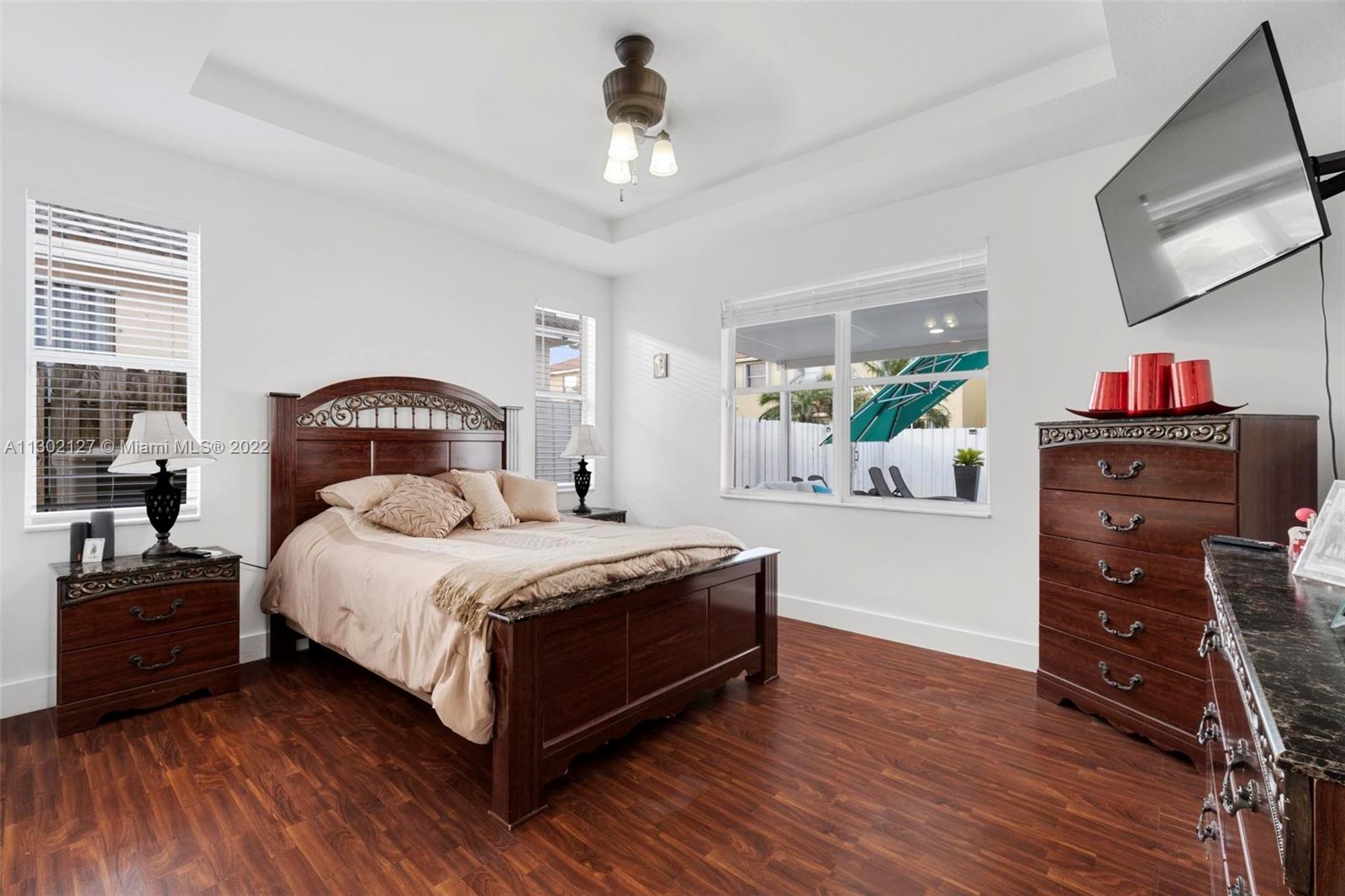 10837 Southwest 246th Street Homestead, FL 33032 - Photo 15 of 44 a bedroom with a bed and a dresser