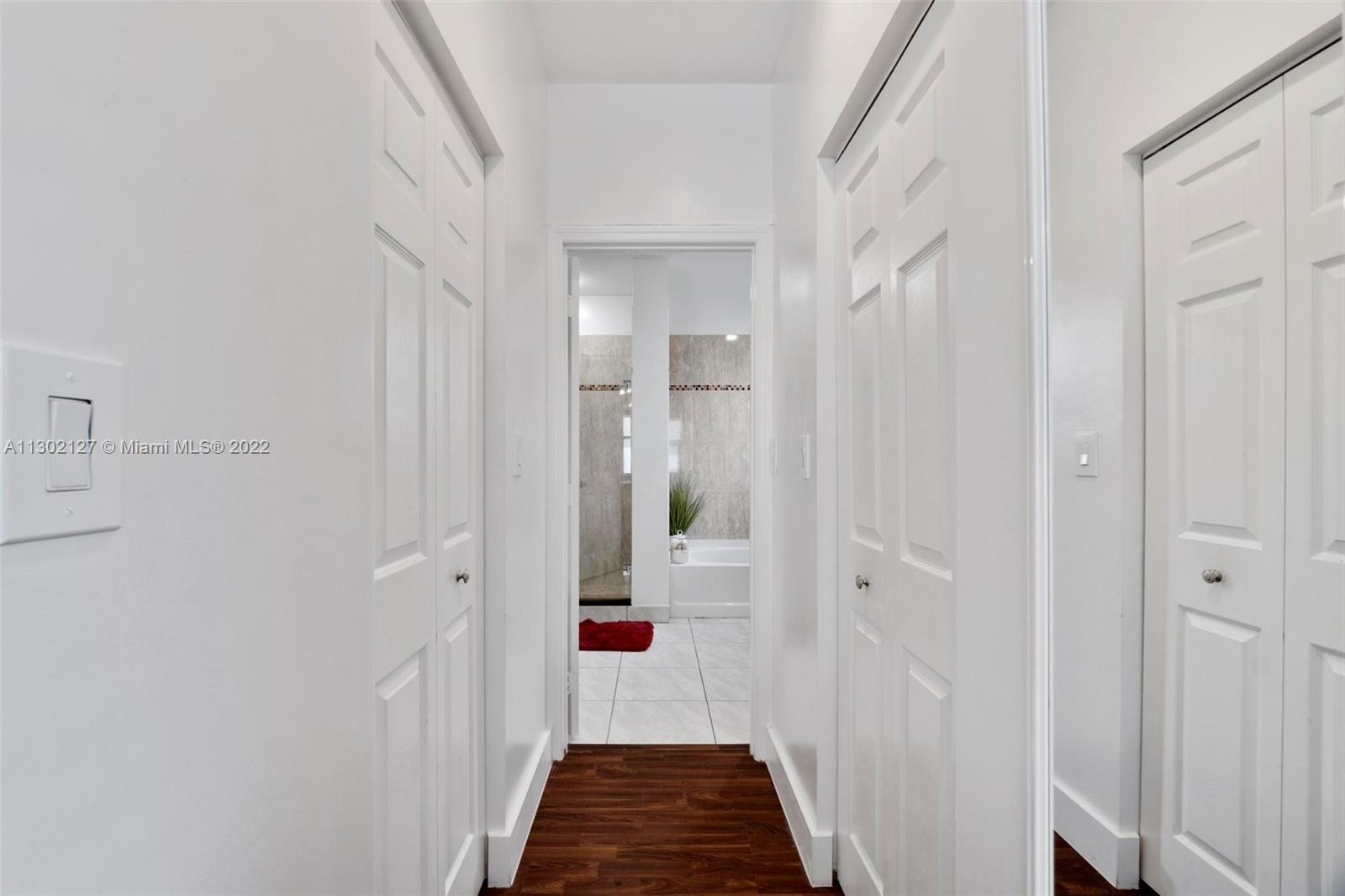 10837 Southwest 246th Street Homestead, FL 33032 - Photo 17 of 44 a view of hallway with wooden floor