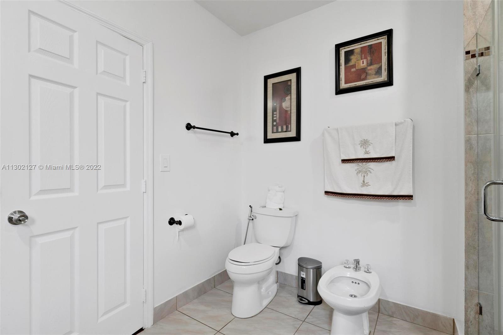 10837 Southwest 246th Street Homestead, FL 33032 - Photo 19 of 44 a white toilet sitting next to a bathroom sink