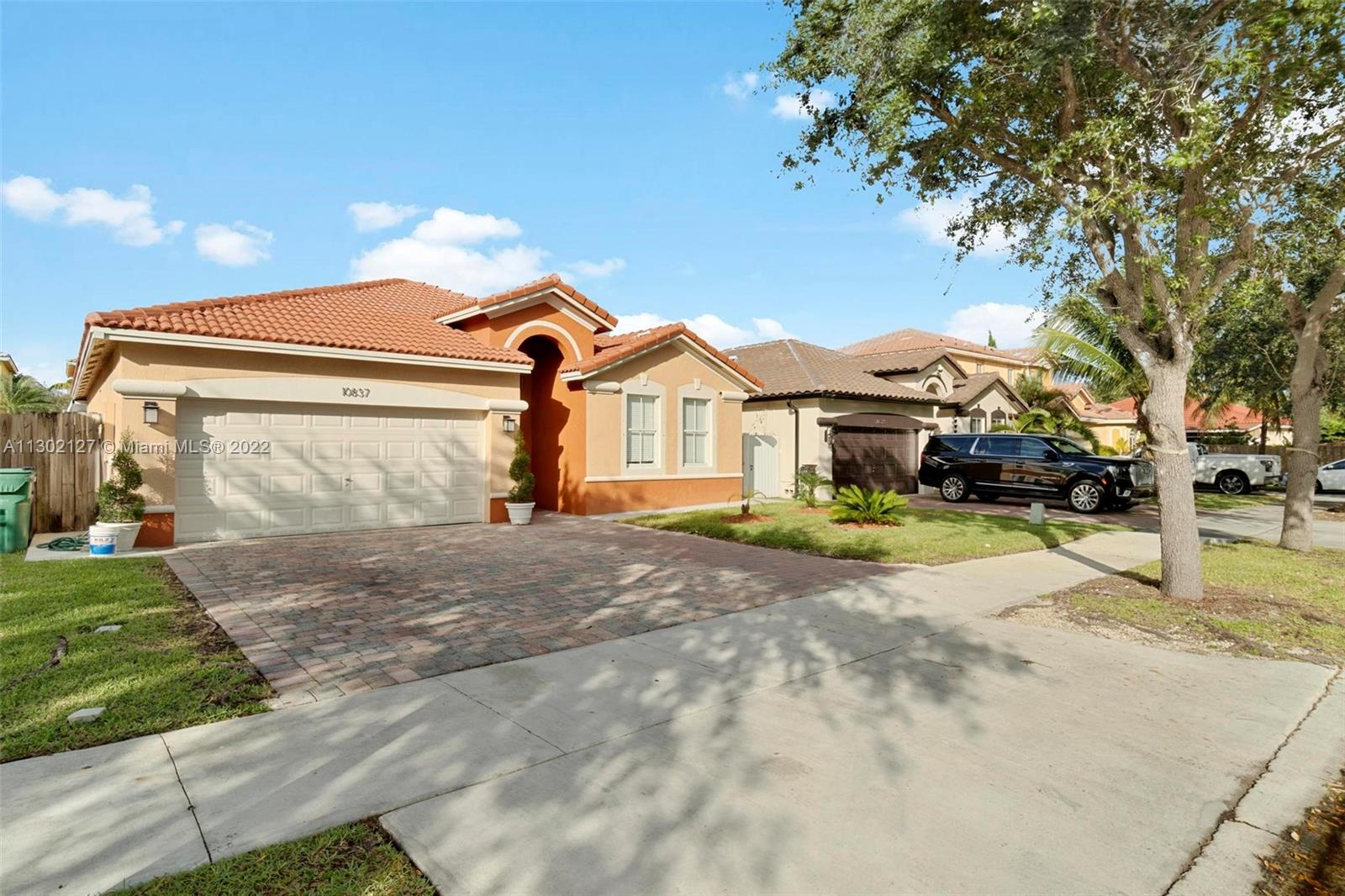 10837 Southwest 246th Street Homestead, FL 33032 - Photo 2 of 44 a front view of a house with a yard