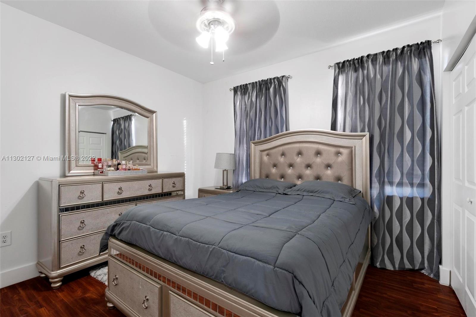 10837 Southwest 246th Street Homestead, FL 33032 - Photo 22 of 44 a bedroom with a large bed and a dresser