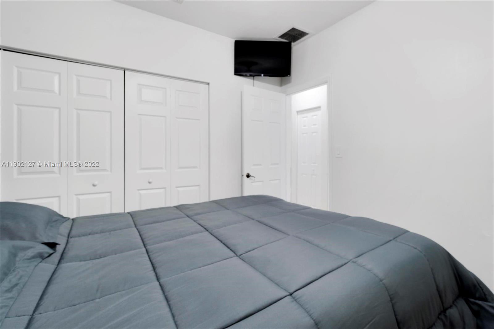 10837 Southwest 246th Street Homestead, FL 33032 - Photo 23 of 44 a view of a livingroom with an empty space and a flat screen tv