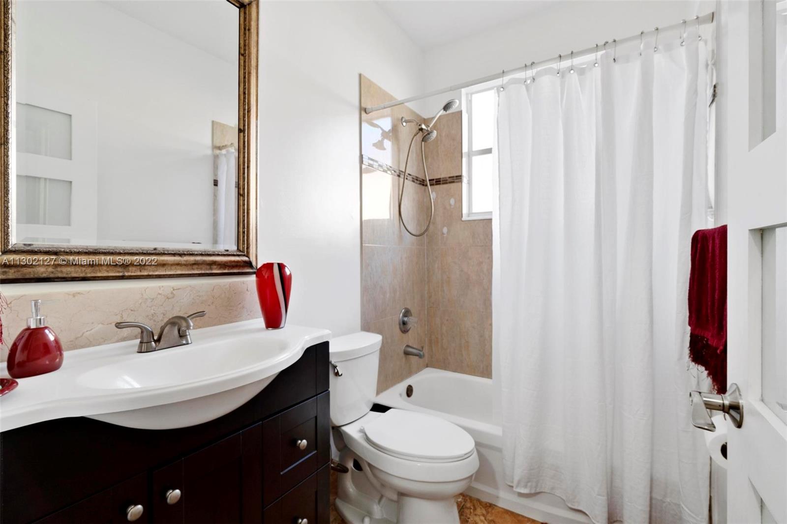 10837 Southwest 246th Street Homestead, FL 33032 - Photo 24 of 44 a bathroom with a sink toilet and shower