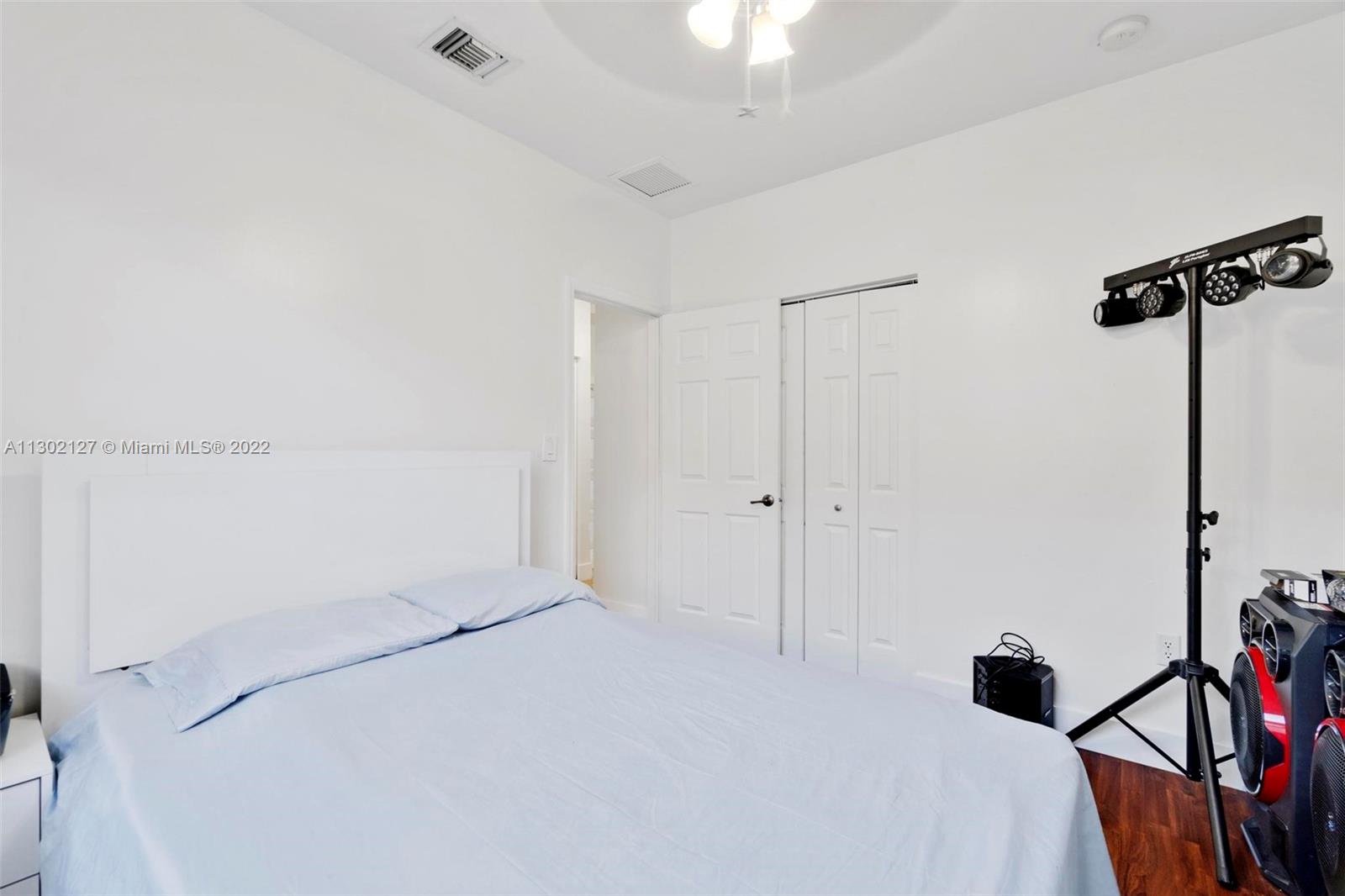 10837 Southwest 246th Street Homestead, FL 33032 - Photo 26 of 44 a bedroom with a bed and a chandelier fan