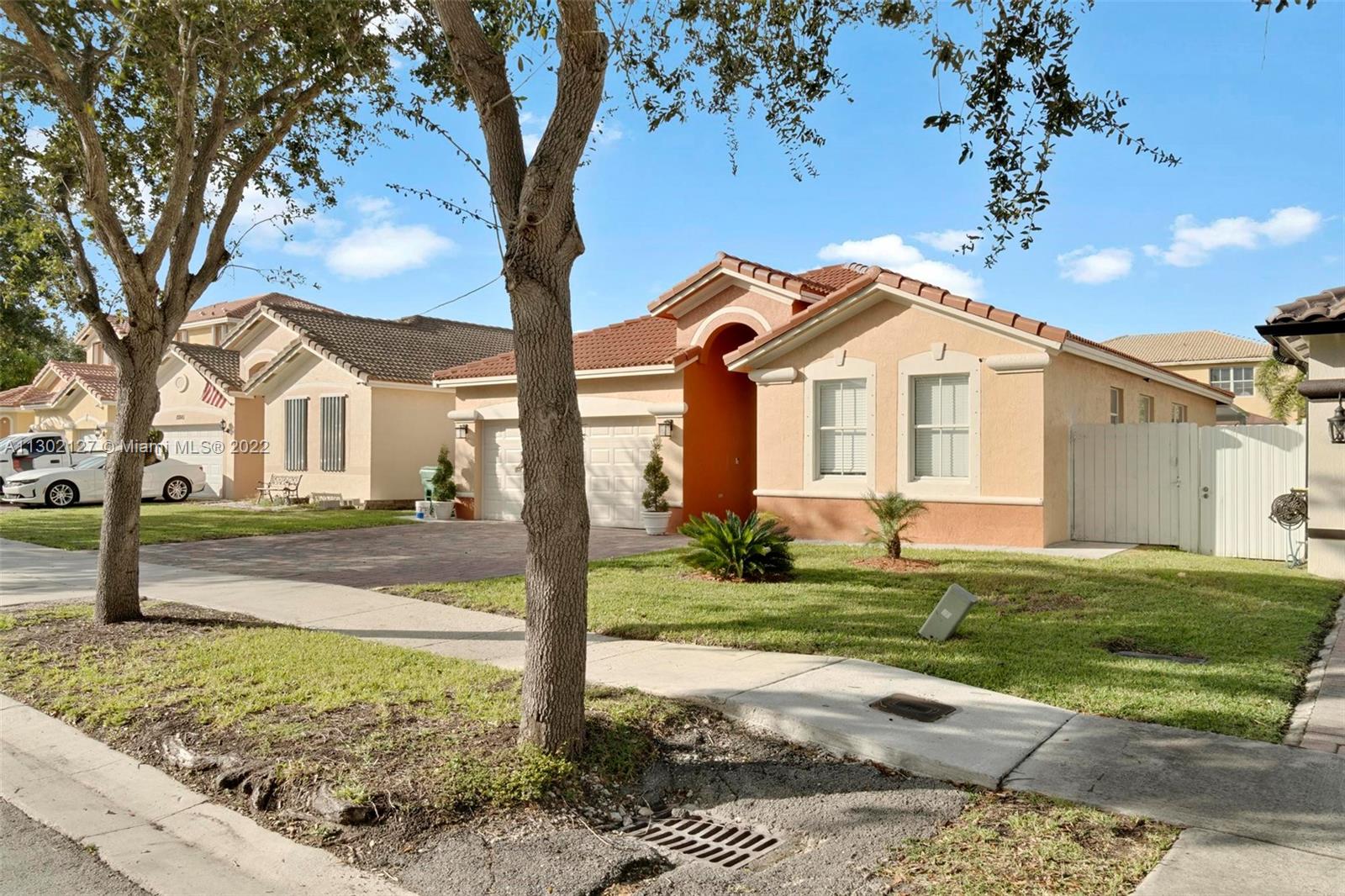 10837 Southwest 246th Street Homestead, FL 33032 - Photo 3 of 44 a front view of a house with a yard
