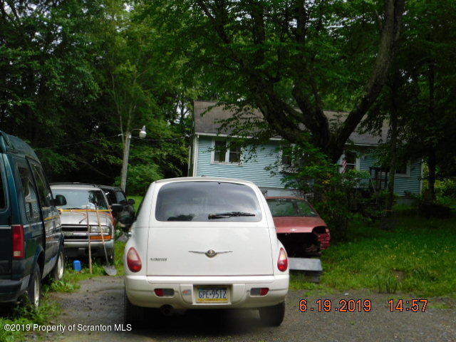 766 Hemlock Road Waymart, PA 18472 - Photo 6 of 7 a car parked in front of a house with a garden