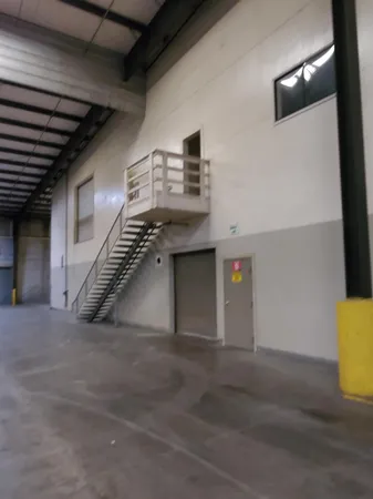 a view of an empty room with a staircase
