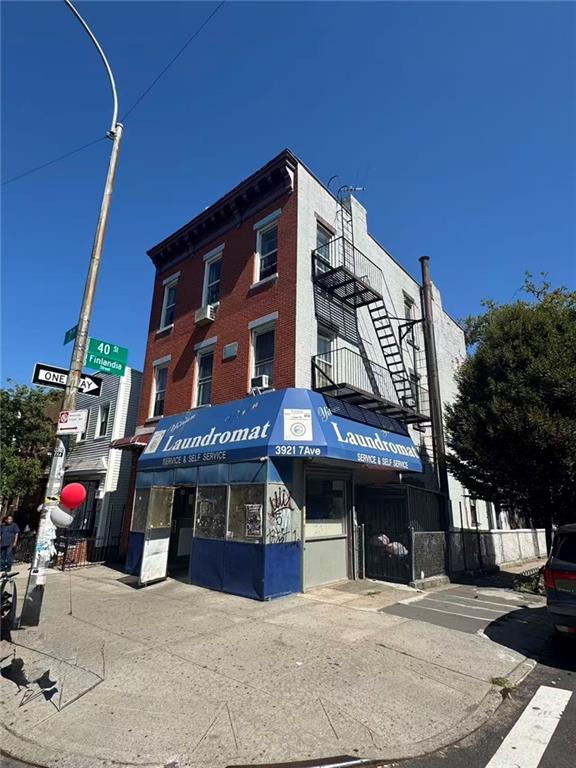 3921 7th Avenue Brooklyn, NY 11232 - Photo 2 of 17 a view of a building with retail shops and traffic signal
