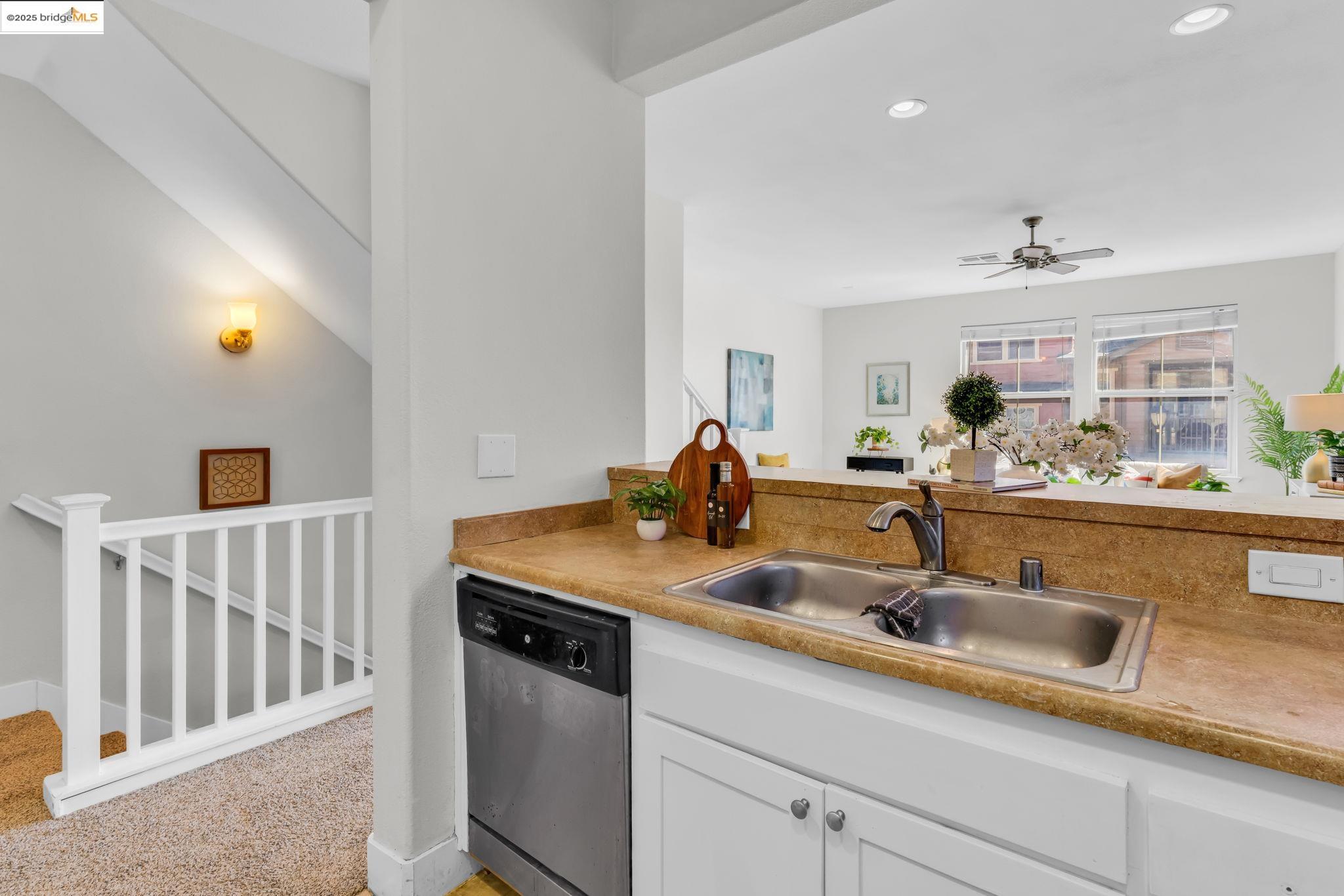 6063 Old Quarry Loop Oakland, CA 94605 - Photo 13 of 36 a kitchen with stainless steel appliances granite countertop a sink and a wooden floor