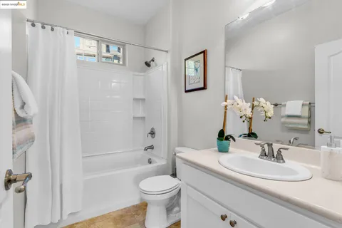 a kitchen with stainless steel appliances granite countertop a sink and a wooden floor