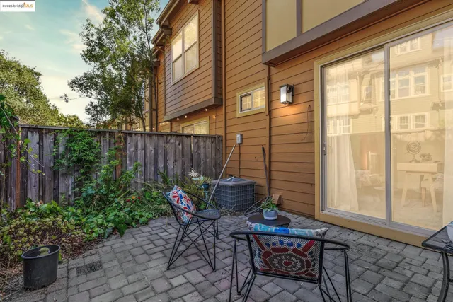 a dining room with furniture and a potted plant