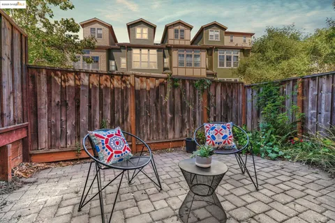 a view of a chairs and table in a backyard