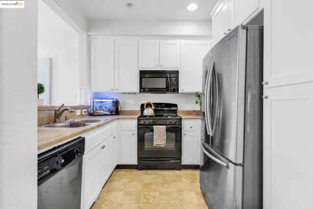 a kitchen with a refrigerator stove and sink