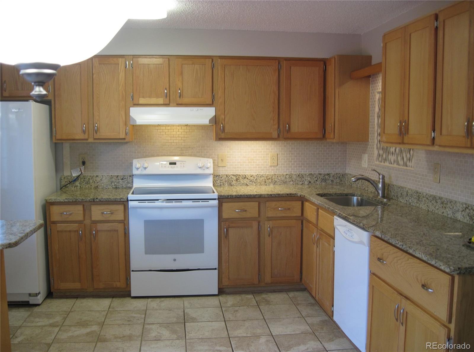 258 West Rockrimmon Boulevard, Unit F Colorado Springs, CO 80919 - Photo 11 of 41 a kitchen with a sink stove and cabinets
