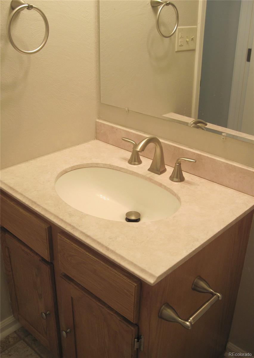 258 West Rockrimmon Boulevard, Unit F Colorado Springs, CO 80919 - Photo 15 of 41 a bathroom with a sink and a mirror