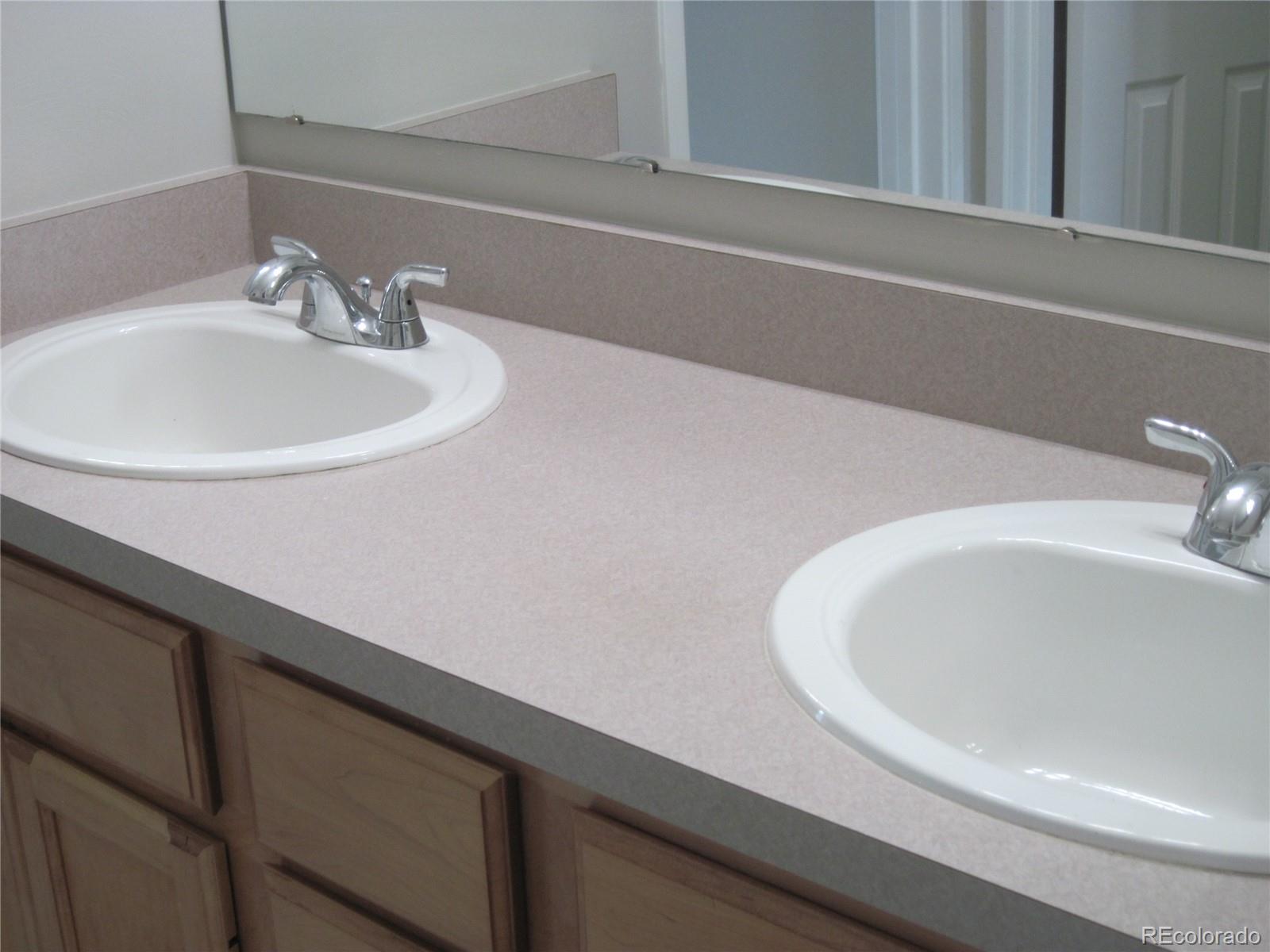 258 West Rockrimmon Boulevard, Unit F Colorado Springs, CO 80919 - Photo 21 of 41 a bathroom with a sink and a mirror