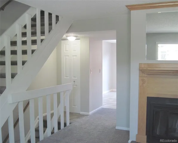 a view of a hallway with windows and stairs