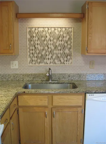 a kitchen with a sink a cabinets and a counter top space