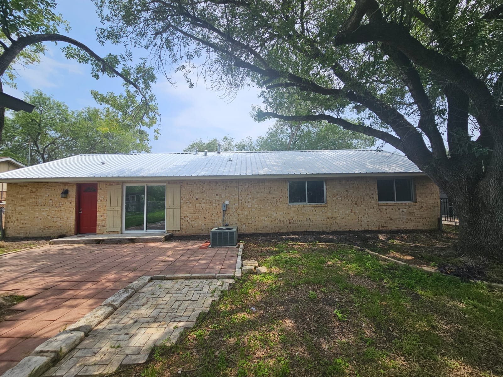 1401 Trinity Street Lockhart, TX 78644 - Photo 28 of 31 Brick exterior with a metal roof