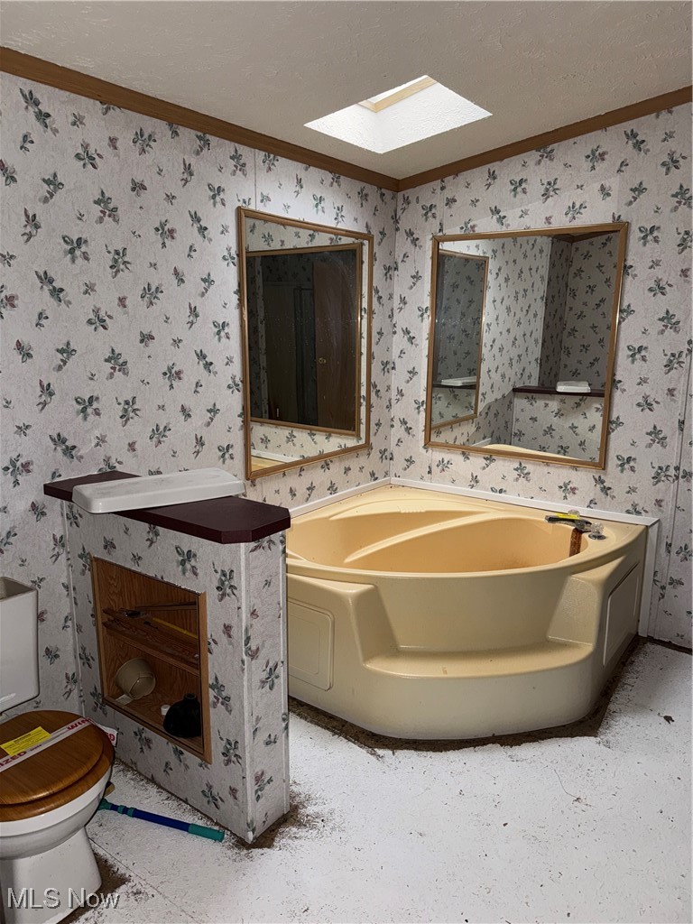 3690 Anderson Anthony Road Leavittsburg, OH 44430 - Photo 11 of 18 Full bathroom with a garden tub, ornamental molding, a textured ceiling, and a skylight