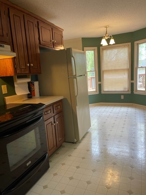 1875 Needmore Road Clarksville, TN 37042 - Photo 9 of 20 a kitchen with granite countertop a refrigerator stove and cabinets