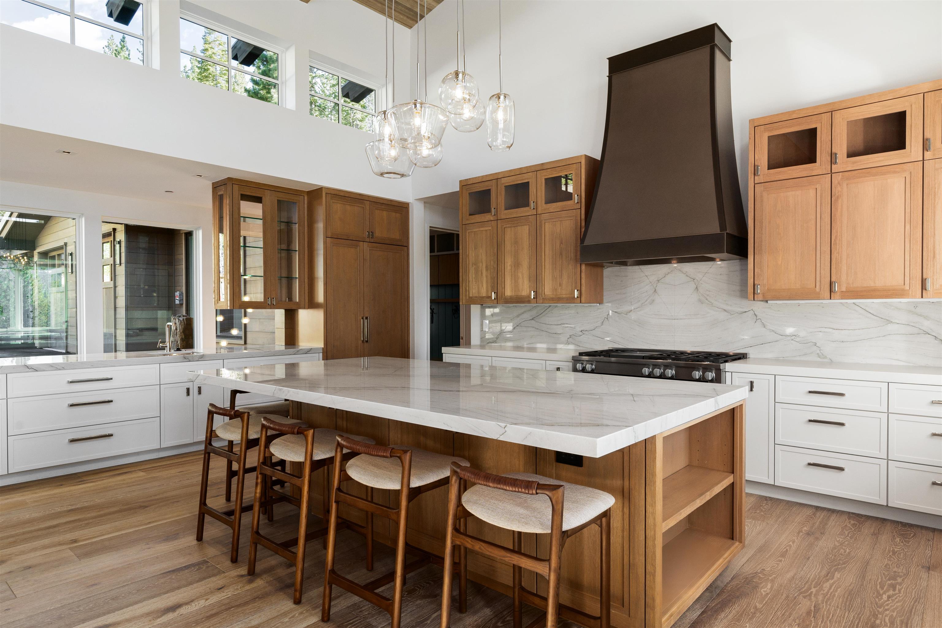 8207 Ehrman Drive Truckee, CA 96161 - Photo 5 of 21 a kitchen with a stove a sink a dining table and chairs