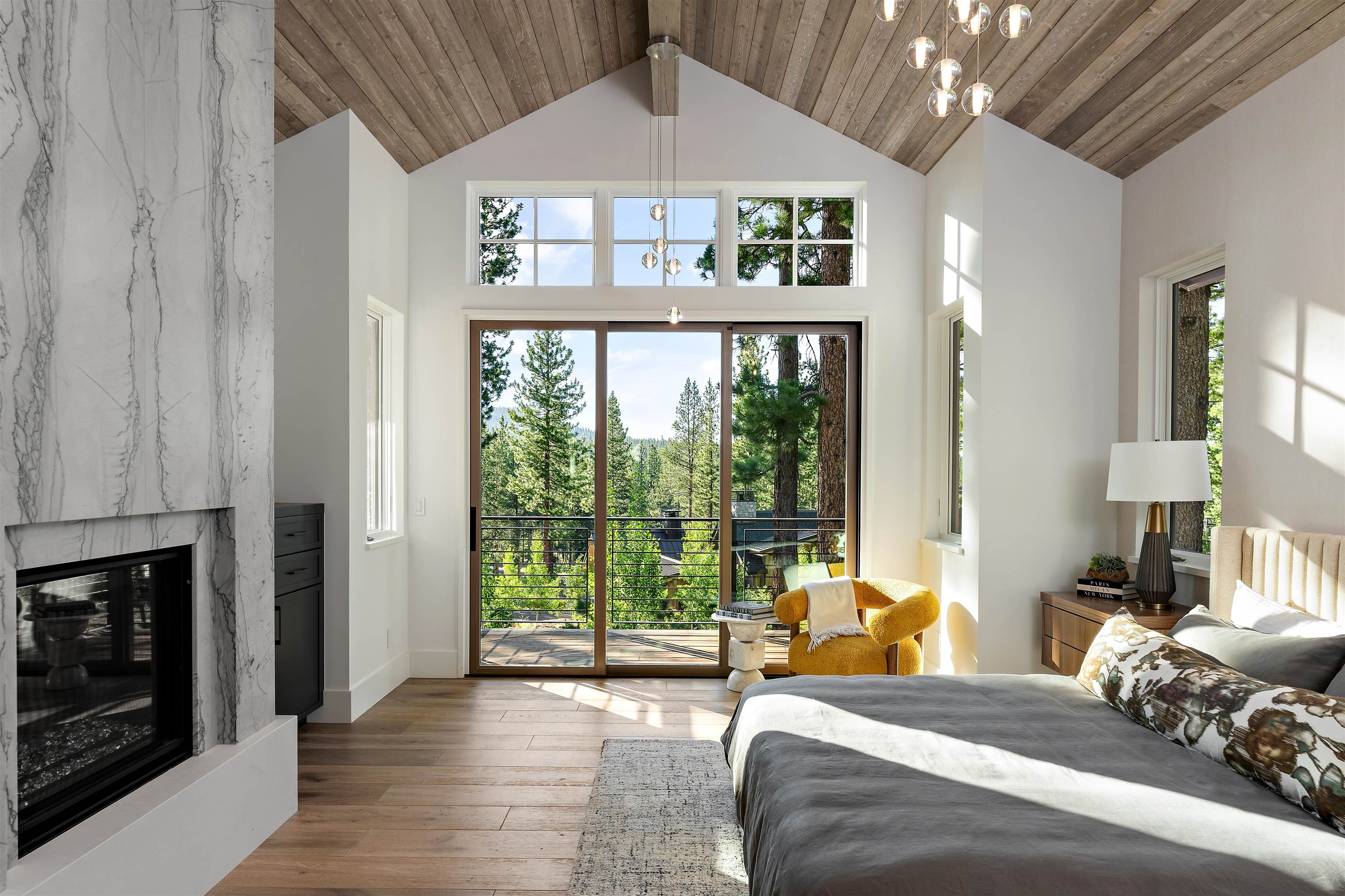 8207 Ehrman Drive Truckee, CA 96161 - Photo 9 of 21 a bedroom with a bed a chandelier and a window